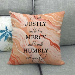 Detail of linen pillowcase featuring pink marble texture and inspirational English quote