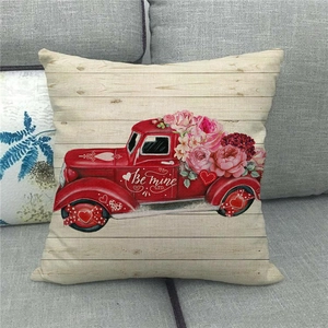 Linen Valentine's Day pillow cover with red vintage truck and pink roses on grey sofa