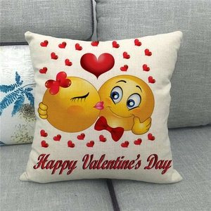 Close-up of linen pillow cover texture with kissing emoji and Happy Valentine's Day print