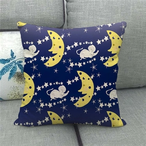 Close-up of linen pillowcase with moon and star pattern on a grey fabric sofa