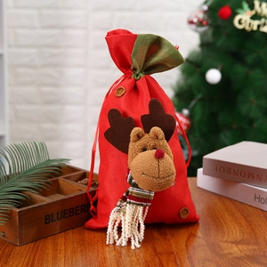 Red Christmas drawstring gift bag with a 3D plush reindeer head and wooden button decor