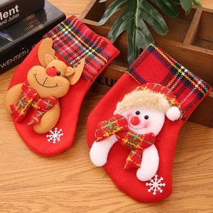 Detail of Christmas stocking ornaments featuring 3D reindeer and snowman with plaid accents