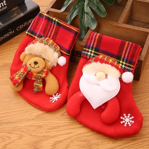 Detail of Christmas stockings with 3D Santa and bear, plaid trim and white snowflake decals
