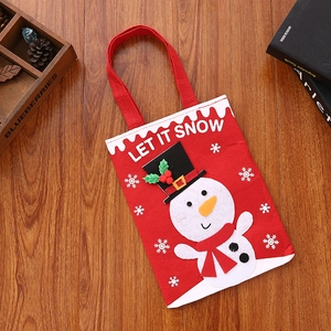 Detail of red Christmas felt gift bag featuring Let It Snow slogan and 3D snowman pattern