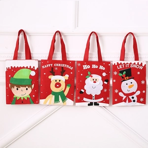 Detailed view of four felt Christmas gift bags with 3D cartoon characters and handles