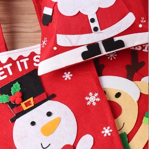 Detailed view of red felt Christmas gift bags with 3D Santa, Snowman and Reindeer applique