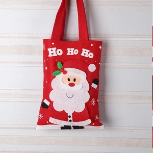 Detail of red Christmas felt gift bag featuring 3D Santa Claus and Ho Ho Ho text