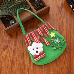Detail of green felt Christmas bag featuring a 3D polar bear and festive tree design