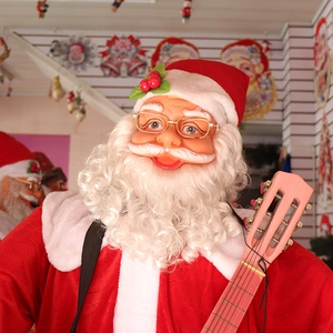 Close-up of musical Santa Claus with gold spectacles, red hat, and a pink toy guitar