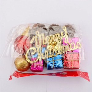 Detailed view of Christmas tree ornaments kit including glitter balls and pinecones in packaging