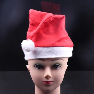 Close-up of classic red Christmas hat with white plush trim and pompom on mannequin head