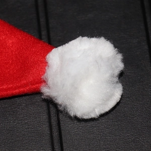 Classic red plush Christmas hat with a fluffy white pom-pom detail for holiday celebrations