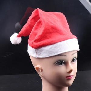 Classic red plush Santa hat with white fur trim and pompom displayed on a mannequin head