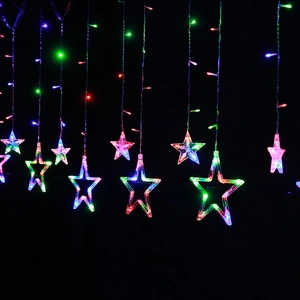 Close-up of multicolor LED star curtain lights with hanging glowing star ornaments