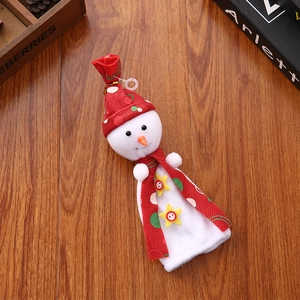 Detailed view of plush snowman Christmas gift bag with star and button on wood