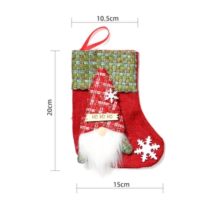 Detailed view of red burlap Christmas stocking with gnome motif and size dimensions