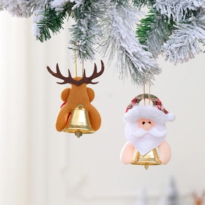 Christmas plush Santa and Reindeer ornaments with gold bells hanging on pine branches