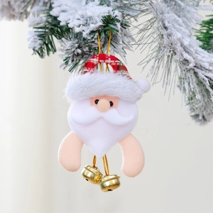 Detail of Santa plush ornament with red plaid hat and golden bells on a snowy pine branch
