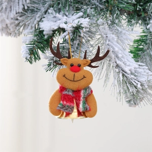 Detailed view of reindeer plush ornament with golden bell on a snowy Christmas tree