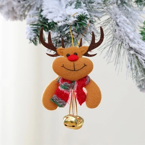 Close-up of reindeer plush ornament with golden bells hanging on a snow-covered pine branch