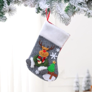 Detail of grey felt Christmas stocking with reindeer, white faux fur, and merry christmas tag