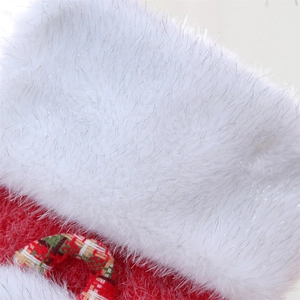 Macro shot of red knit Christmas stocking with silver glitter white faux fur cuff