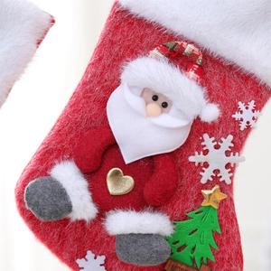 Detail of Christmas stocking featuring 3D Santa Claus doll with wood Merry sign