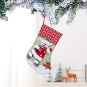 Detail of Christmas stocking with 3D skiing snowman and Merry Christmas wooden tag