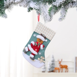 Detail of green Christmas stocking with 3D reindeer decor and wooden Merry Christmas tag