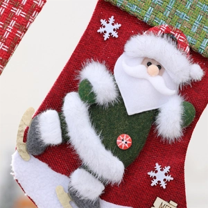 Detail of burlap Christmas stocking featuring 3D Santa Claus and personalized wooden tag