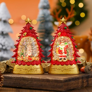 Christmas tree snow globe lantern with Santa Claus and golden star, festive warm light