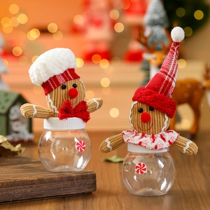 Close-up of mini gingerbread man candy jars with festive hats and transparent containers