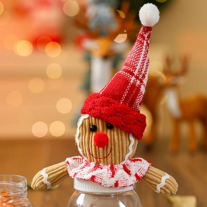 Detailed view of gingerbread man jar lid with red knitted hat and corduroy texture