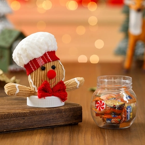 Close-up of a gingerbread man jar lid with knit texture and candy inside a clear jar