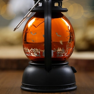 Detail of Halloween pumpkin lantern with bats, ghost prints and a metal handle