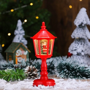 Close-up of a red Christmas street lamp decor with Santa figure and warm LED lighting