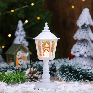 Close-up of lighted white Christmas lantern with snowman and glittery water inside