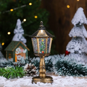 Detail of vintage Christmas snow globe lantern with miniature tree and glitter snow effect