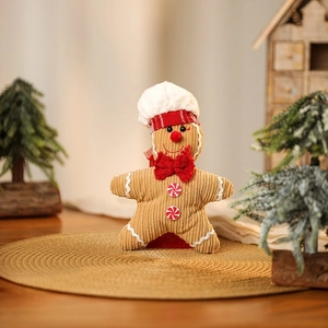 Detail of plush gingerbread chef doll with corduroy texture and holiday decorations