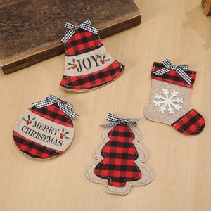 Christmas silverware holders with red plaid and burlap fabric on a light wood background