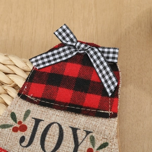 Detail of Christmas jute cutlery holder with red buffalo plaid and JOY print design