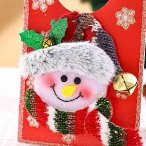 Close-up of plush snowman Christmas door hanger with striped scarf and golden bell
