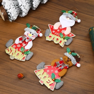 Detailed view of Christmas dolls with Joy and Noel text on a rustic wood background