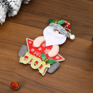 Detail of Santa Claus star ornament with golden JOY letters on dark wood texture background