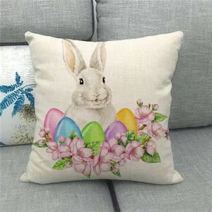 Close-up of Easter linen pillowcase featuring rabbit, colorful eggs and cherry blossoms