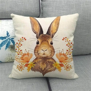 Close-up of linen Easter cushion cover featuring a hand-painted bunny and floral pattern