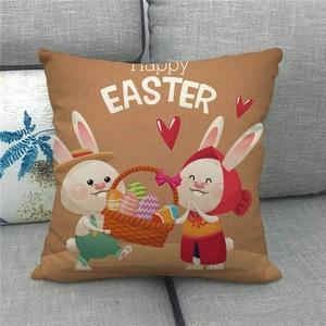 Linen Easter pillow cover with Happy Easter text, bunnies, and colorful eggs on sofa