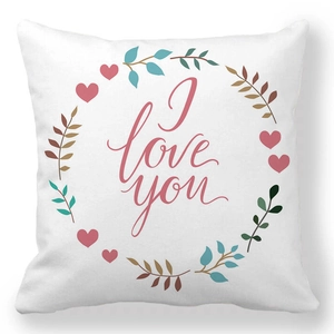 Detail showing the I love you script and floral heart wreath on a linen pillowcase