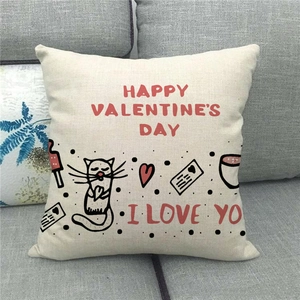 Close-up of linen pillow cover with Happy Valentine's Day text and red heart illustrations