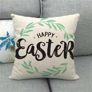Detail of Happy Easter cushion cover with wreath design on textured linen sofa pillow
